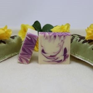 By the Sea Soap Shoppe bar of soap called "Rose and Geranium" with Rose essential  oil and Geranium essential oil. Bars are white with purple swirls. Essential oils, all natural ingredients, wonderful scent! Vegan. $7.00, 3 for $20.00. Handmade in Prince Edward Island.