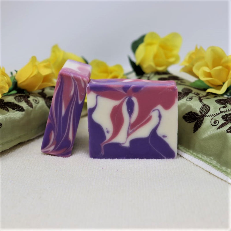 By the Sea Soap Shoppe bar soap called "Blackberry and Magnolia". White with purple and red swirls. A sweet scent of blackberry, apple, magnolia and melon. Natural ingredients, vegan, moisturizing. $7.00 or 3 for $20.00. Handmade in Prince Edward Island, Canada