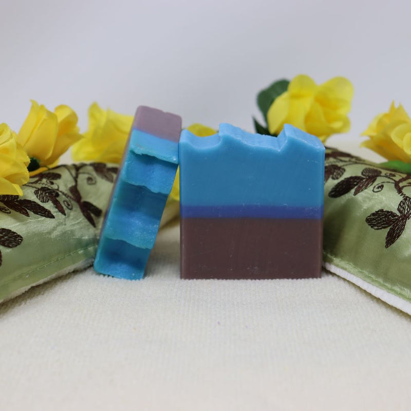 By the Sea Soap Shoppe Island Summer soap. The bottom of the bar is brown, for sand, there is a strip of dark blue for the ocean and the top is a lighter blue for the sky. The soap is shaped to show waves on the top. Natural ingredients, vegan. $7.00 each, 3 for $20.00. Handmade in Prince Edward Island, Canada