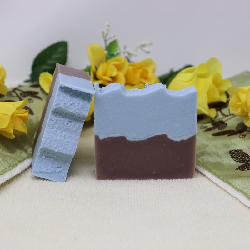 By the Sea Soap Shoppe bar of soap with brown "waves" on the bottom and blue waves on the top of the bar. Castor oil for extra moisture and lather. Natural ingredients. $7.00 each. Handmade in Prince Edward Island, Canadaon top to imitate standing on the sand looking out at the ocean. 