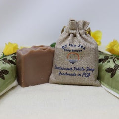 By the Sea Soap Shoppe brown Sandalwood Potato Soap bar. Potato soap is made with potato water which brings vitamins, minerals and other nutrients which are good for your skin. Soap has a brown colour. Handmade in PEI, natural ingredients, vegan. $7.00 each, 3 for $20.00