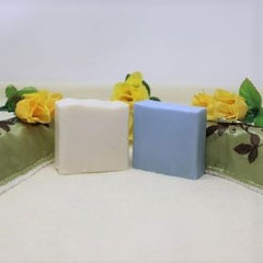 This picture shows 2 bars of By the Sea Soap Shoppe Latherific soap; one is white and one is blue. This soap is unscented and contains castor oil which gives it extra lather and moisturizing.  Vegan, all-natural ingredients. Handmade in Prince Edward Island, Canada $6.00 each. 