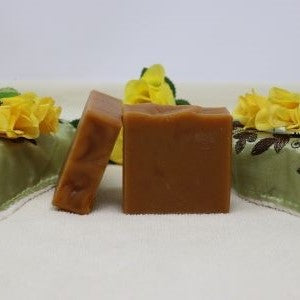 By the Sea Soap Shoppe bar of soap called Turmeric soap. Picture shows 2 brown bars of soap. The soap has both turmeric and chamomile, includes both orange essential oil and lemongrass essential oil, as well as shea butter and avocado oil. Vegan, all-natural ingredients, handmade in Prince Edward Island, Canada. $7.00 each. 