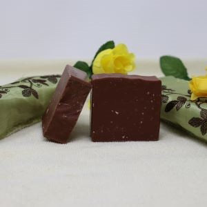 Picture shows 2 By the Sea Soap Shoppe brown bars of soap called "Whispering Woods". Soap has a woodland fragrance. Soap is $7.00. Soap includes natural ingredients, and has no parabens, phthalates or harsh chemicals. Vegan. Handmade in Prince Edward Island. 