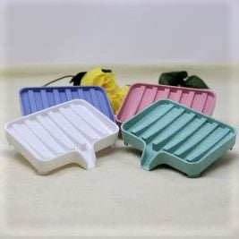 Pictures shows soap dishes in four colours, white, green, blue and pink.