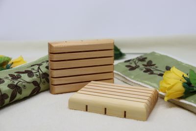 Light brown wooden soap saver made of white pine. It has five slats as well as holes for drainage.  Made of white pine, it is durable and stands up to water. $5.00 each.