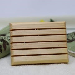 Light brown wooden soap saver made of white pine. It has five slats as well as holes for drainage.  Made of white pine, it is durable and stands up to water. $5.00 each.