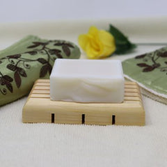 Light brown wooden soap saver made of white pine. It has five slats as well as holes for drainage.  Made of white pine, it is durable and stands up to water. $5.00 each.